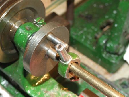 Brass mounted in lathe 'dog' between centres